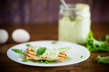 green bread spread of arugula, curds and eggs with fried toast