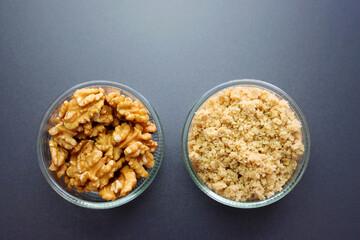 Shelled walnuts and walnut flour. Walnuts on a gray background.