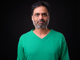 Portrait of mature bearded Indian man with curly hair