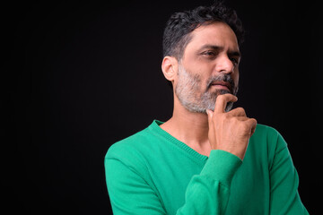 Portrait of mature bearded Indian man with curly hair