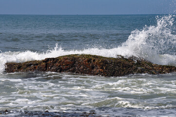 Sea breeze breaking on the rocks