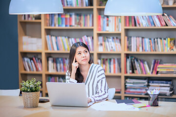 Young business freelancer working on smart computer while thinking for new ideas at Co Working Space office.Conceptual for startup small businesses entrepreneur and freelance.