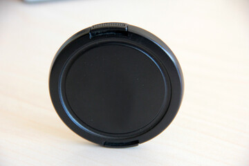 black lens cap on white background