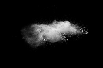 White powder explosion isolated on black background. White dust particles splash.Color Holi...