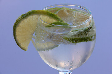mineral water and lemon in a glass cup