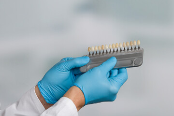 Close up of shade guide to check veneer of tooth crown in a dental laboratory for bleaching 