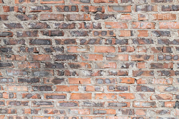 Old burnt red brick. Brick wall after fire.