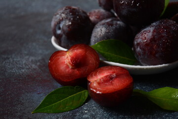 Juicy plums in a plate. Fresh Blue plums. 