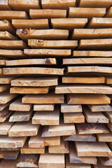 Building material in the form of fresh wooden planks at a road repair site. The repair process. Close-up.