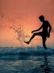 silhouette of a woman jumping on the beach