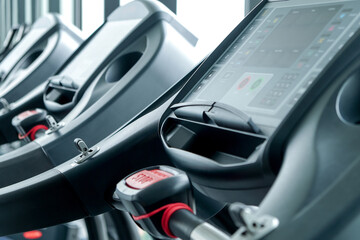 Naklejka premium Detail image of Treadmill in fitness room background 