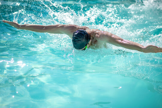 Professional male swimmer having a workout in pool