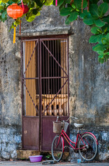 Fototapeta na wymiar House gate and bicycle in Hue, Central Vietnam