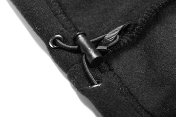 Inner drawcord of a black fleece jacket, close-up