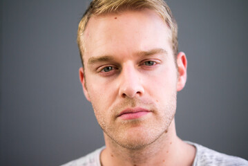 Fototapeta premium Portrait of young handsome man with blond hair