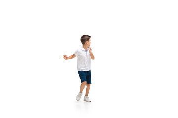 Happy kids, little and emotional caucasian boy jumping and running isolated on white background. Look happy, cheerful, sincere. Copyspace for ad. Childhood, education, happiness concept.