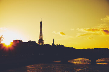 Cityscape of Paris, France and famous landmark Eiffel tower in silhouette just before sunset.