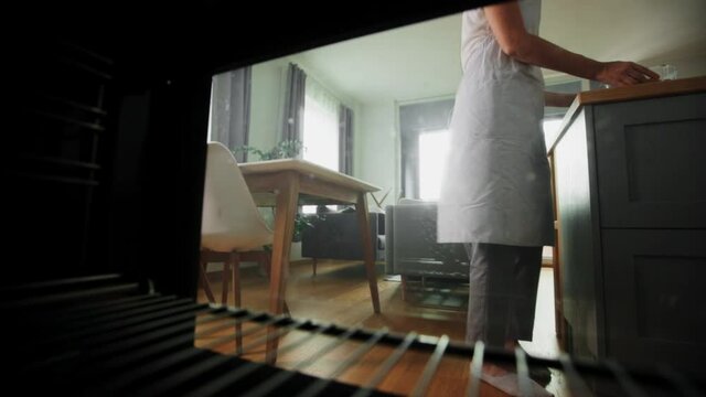 Culinary, Food And People Concept - Woman Cooking Salmon Fish With Vegetables In Baking Dish In Oven At Home Kitchen