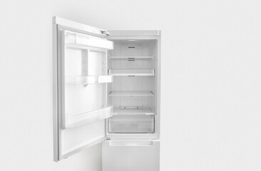 Open white fridge on white wall background