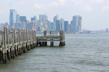 A boardwalk in front of the Manhattan skyline.