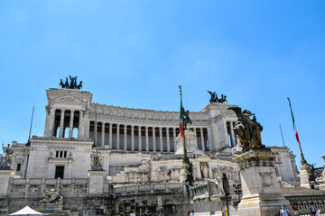Fototapeta na wymiar Side view of the monumental complex of the Vittoriano in the center of Rome, made of marble and bronze statues, also known as 