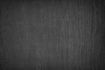 Black plywood rough surface texture. Dark wood backdrop. Abstract wooden background