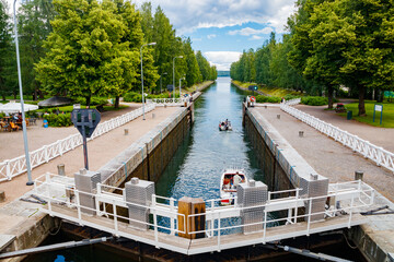 Fototapeta premium Asikkala, Finland - 16 July 2020: Vaaksy Canal between two big lakes Vesijarvi and Paijanne. Gateway is open for boats going though.