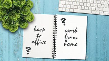 continue working from home or going back to the office concept with note pad and computer keyboard on rustic wooden table