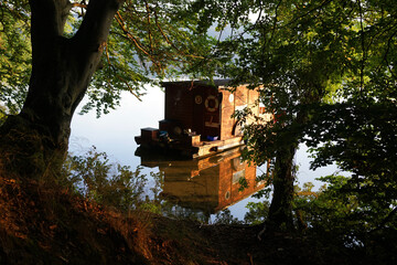 Wooden houseboat at sunrise at Mecklenburger lake district         