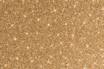 Luxury gold glitter texture with bright sparkles and flickers on the white isolated background. Shiny glamour background.