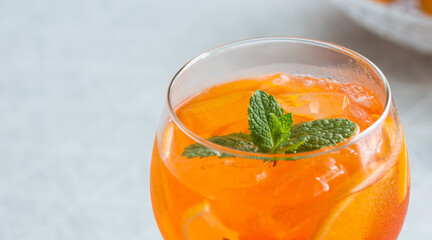 colorful cocktail drink aperol gin tonic cocktails in wine glasses on the table at home, afternoon drinks at home, after work drink
