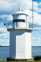 Fototapeta na wymiar White lighthouse on Pulkkilanharju Ridge at lake Paijanne, Paijanne National Park, Finland.