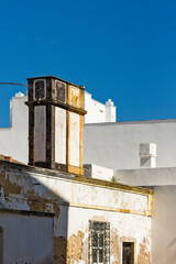 Fototapeta na wymiar traditional old chimney on a terrace of a house in Faro, Algarve, Portugal
