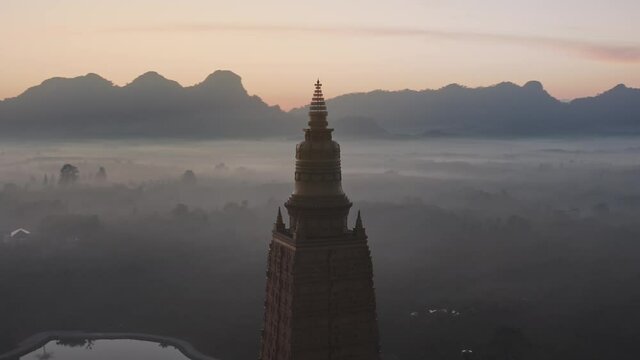 Drone aerial shot of sunrise over Wat Mahathat Watchiramongkhon (Wat Bang Thong) in Krabi, Thailand