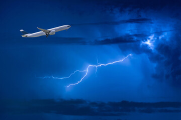Commercial airplane take off flying over storm clouds and lightning.