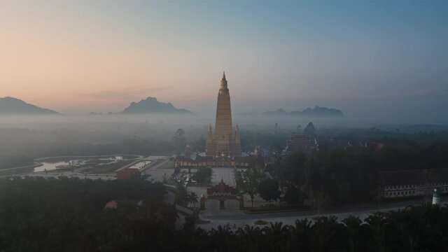 Drone aerial shot of sunrise over Wat Mahathat Watchiramongkhon (Wat Bang Thong) in Krabi, Thailand