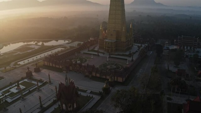Drone aerial shot of sunrise over Wat Mahathat Watchiramongkhon (Wat Bang Thong) in Krabi, Thailand