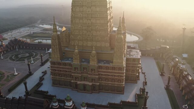 Drone aerial shot at sunrise over Wat Mahathat Watchiramongkhon (Wat Bang Thong) in Krabi, Thailand