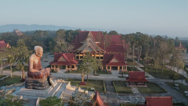 Drone aerial shot of sunrise over Wat Mahathat Watchiramongkhon (Wat Bang Thong) in Krabi, Thailand