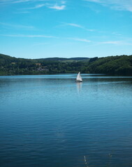Fototapeta na wymiar Photo of a lake in the south of France, where a sailboat is sailing