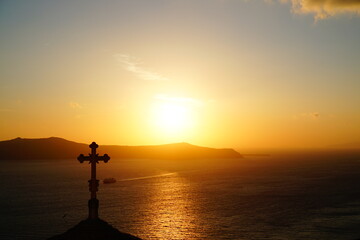 beautiful sunset with religious objects in santorini island, Oia, Greece, Europe