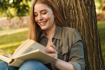 Girl reading a book in park