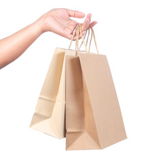 Woman's hand hold the shopping paper bags isolated on white background, with clipping path