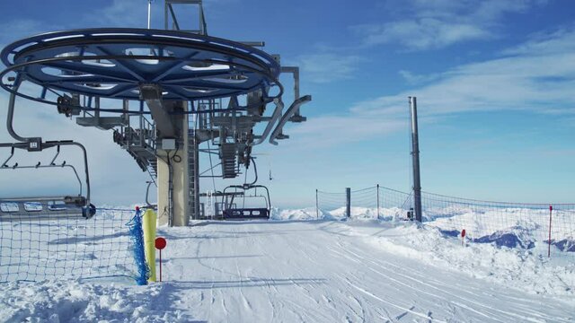 Skiers getting off the ski lift at the top of La Plagne ski resort, Tarentaise, Savoy, French Alps