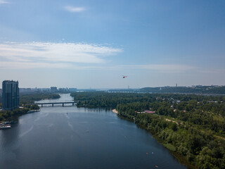 Fototapeta na wymiar A helicopter over the Dnieper river in Kiev.