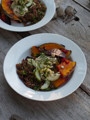Wholefoods pumpkin and quinoa dish on wooden table