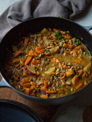 Rustic carrot and lentil curry in pot