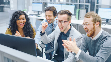 In Modern Office: Diverse Team of Businessmen and Businesswoman Work on Computer, Having Discussion, Successfully Finding Problem Solution, Surprised and Cheerfully Celebrate.