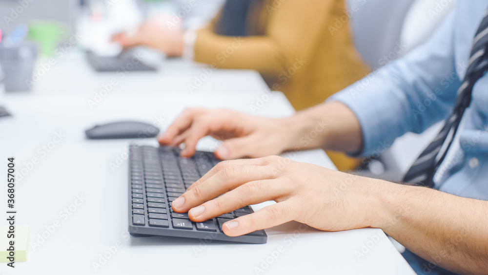 Aufkleber Close-up Shot of Man typing on a Keyboard, Using Mouse. Businessman / Office Clerk Working on Desktop Computer in Bright Office 