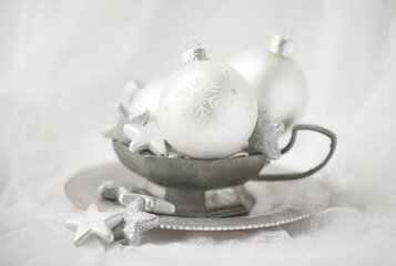 Original Christmas still life photograph of silver and white Christmas ornaments in a pewter bowl on white